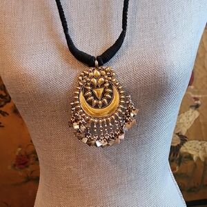 Ornate Gold and Silver Necklace with Crescent Moon Pendant.